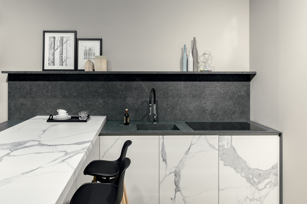Inspiration for a small modern l-shaped open plan kitchen with an integrated sink, white cabinets, tile benchtops, grey splashback, porcelain splashback, porcelain floors, a peninsula and white benchtop.