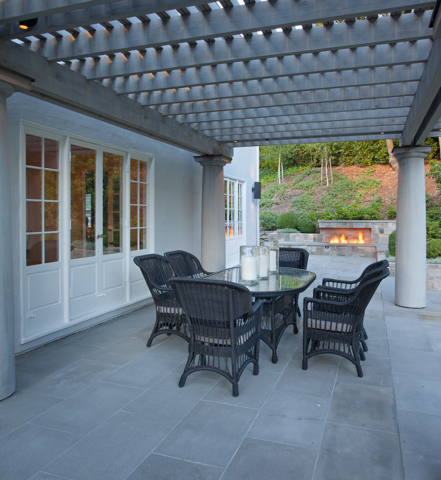 Design ideas for a large traditional patio in San Francisco with a fire feature and natural stone pavers.