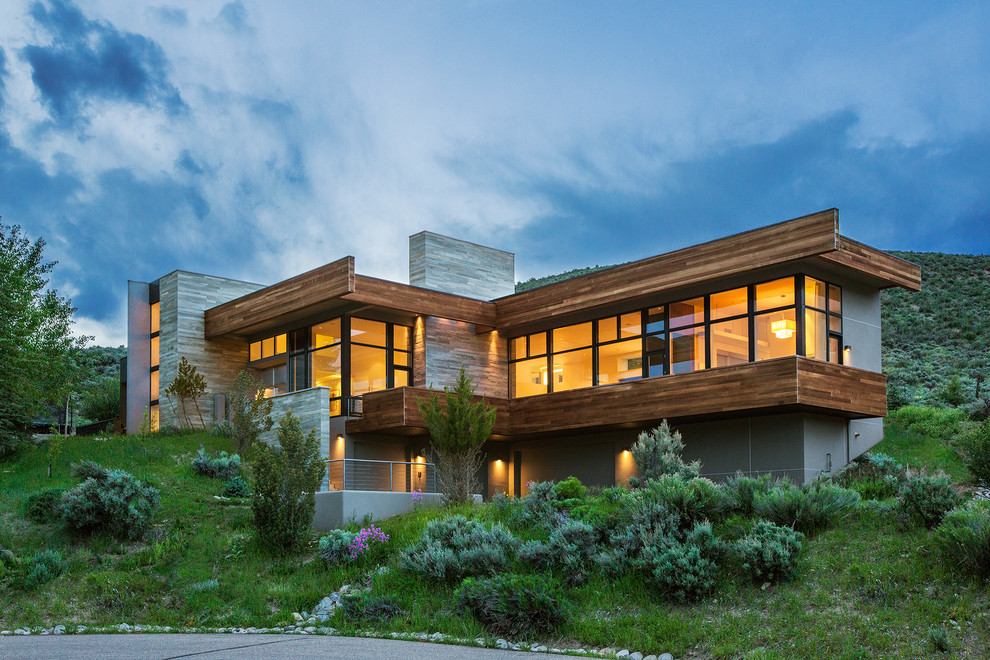 Design ideas for an expansive contemporary two-storey grey exterior in Denver with a flat roof and wood siding.