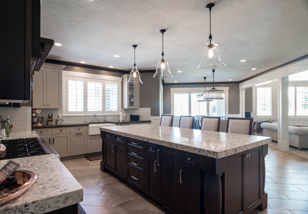 Large transitional u-shaped eat-in kitchen in Salt Lake City with a farmhouse sink, recessed-panel cabinets, dark wood cabinets, granite benchtops, white splashback, glass tile splashback, stainless steel appliances, ceramic floors, with island and beige floor.