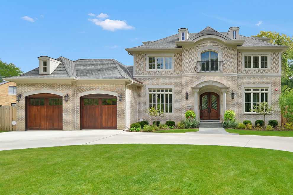 Inspiration for an expansive traditional three-storey brick beige exterior in Chicago with a gable roof.