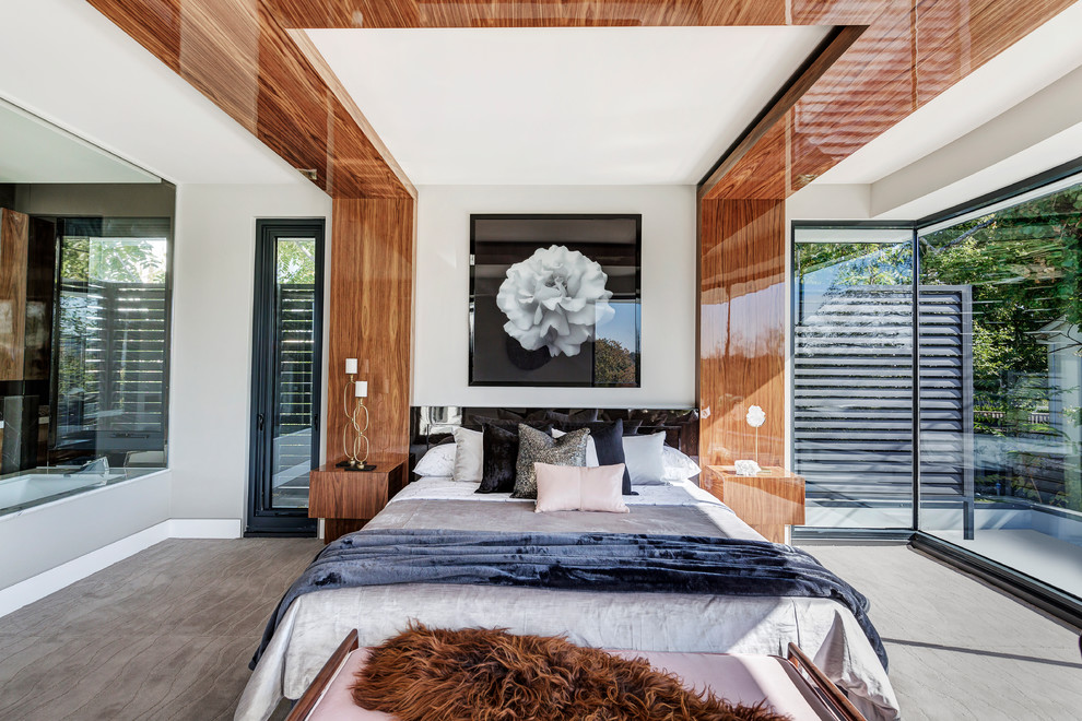 Modern bedroom in Melbourne with grey walls, carpet and grey floor.