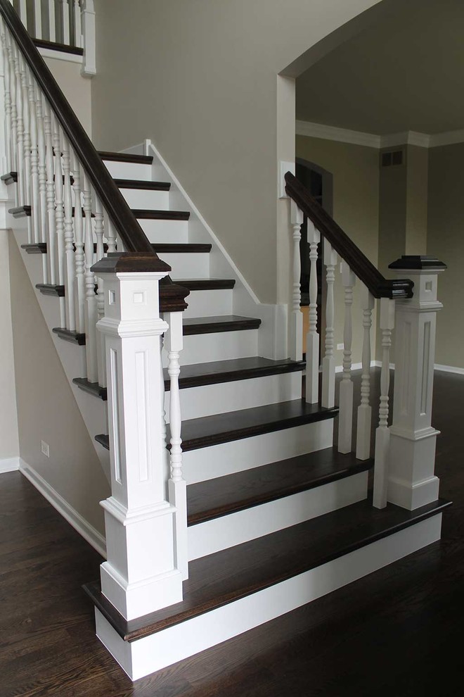 Photo of a mid-sized traditional wood l-shaped staircase in Chicago with painted wood risers.