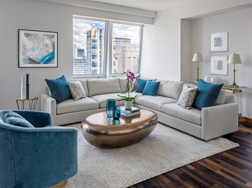 Photo of a contemporary formal living room in New York with white walls and dark hardwood floors.