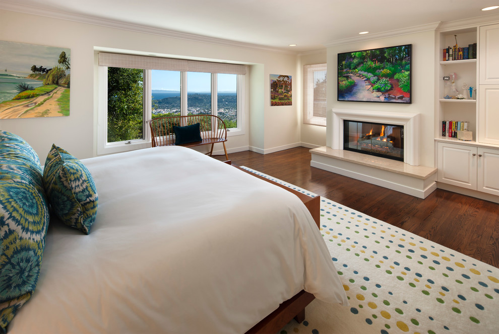 Mid-sized traditional master bedroom in Santa Barbara with white walls, dark hardwood floors and a standard fireplace.