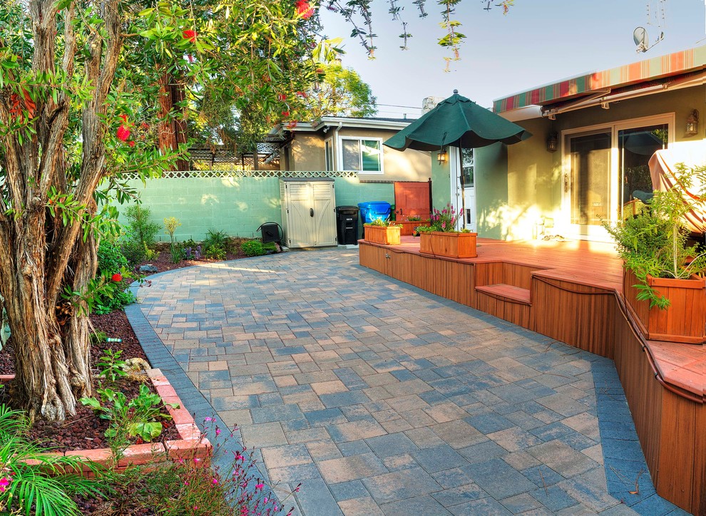 Photo of a small contemporary backyard patio in Los Angeles with concrete pavers.