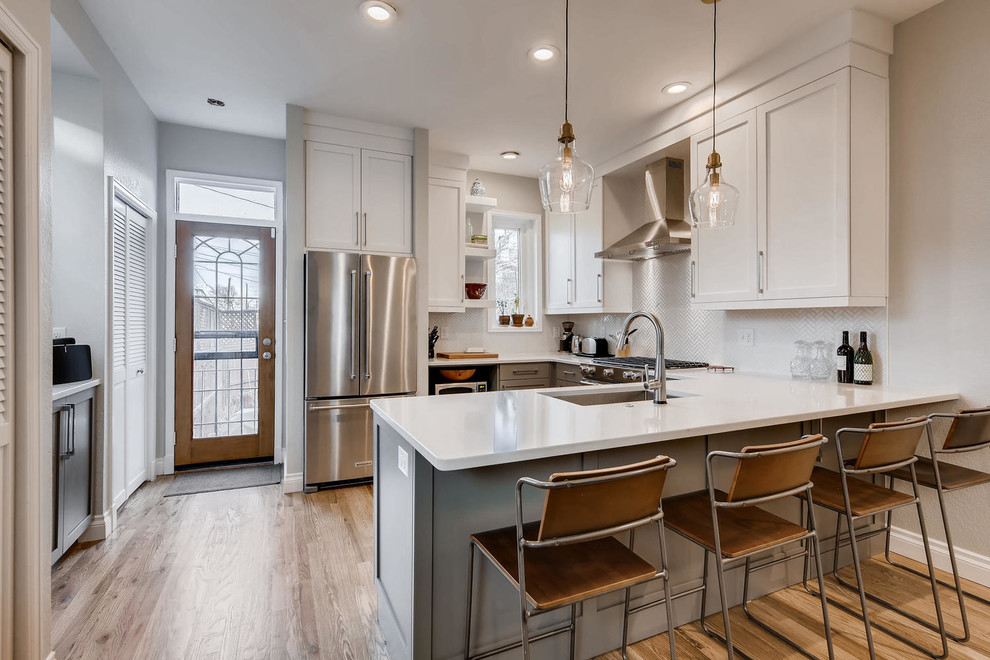 Example of a transitional kitchen design in Denver
