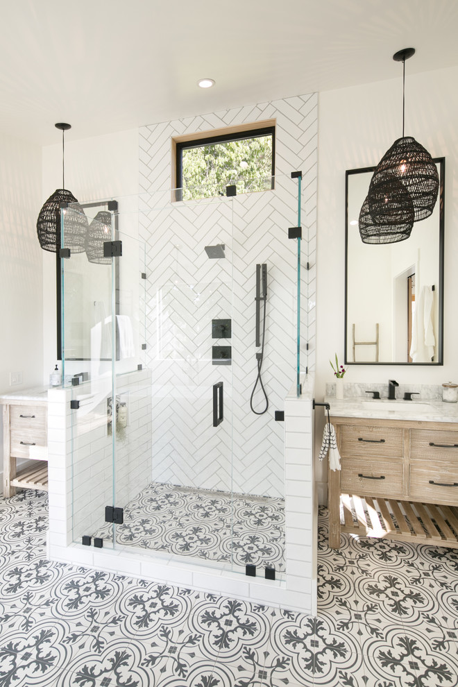 This is an example of a large country master bathroom in San Francisco with flat-panel cabinets, distressed cabinets, an alcove tub, a two-piece toilet, white tile, ceramic tile, white walls, ceramic floors, a drop-in sink, marble benchtops, white floor, a hinged shower door and grey benchtops.