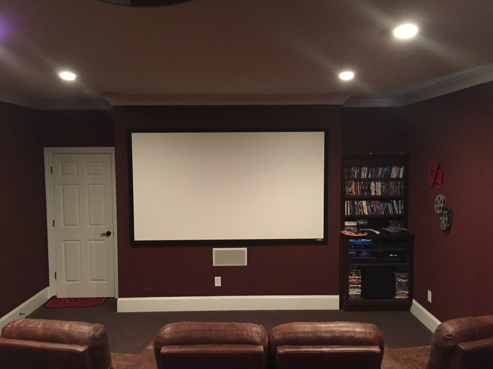 Photo of a mid-sized contemporary enclosed home theatre in Other with brown walls, carpet and a projector screen.