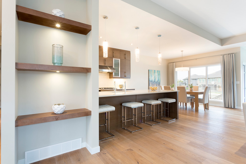 Kitchen - transitional light wood floor kitchen idea with dark wood cabinets, stainless steel appliances and an island