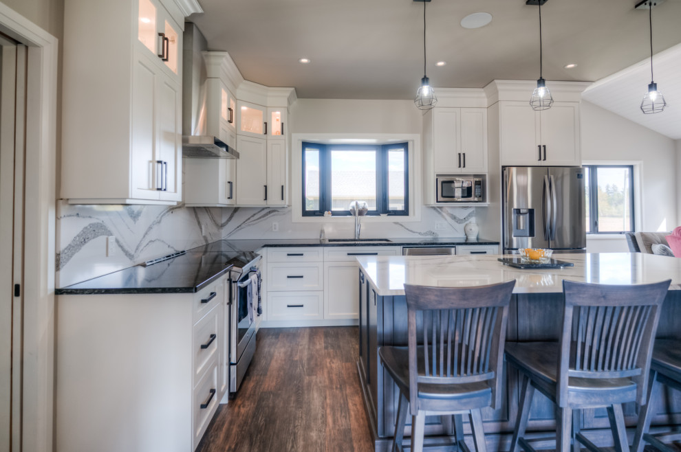 Inspiration for a transitional eat-in kitchen remodel with shaker cabinets, white cabinets, stainless steel appliances and an island