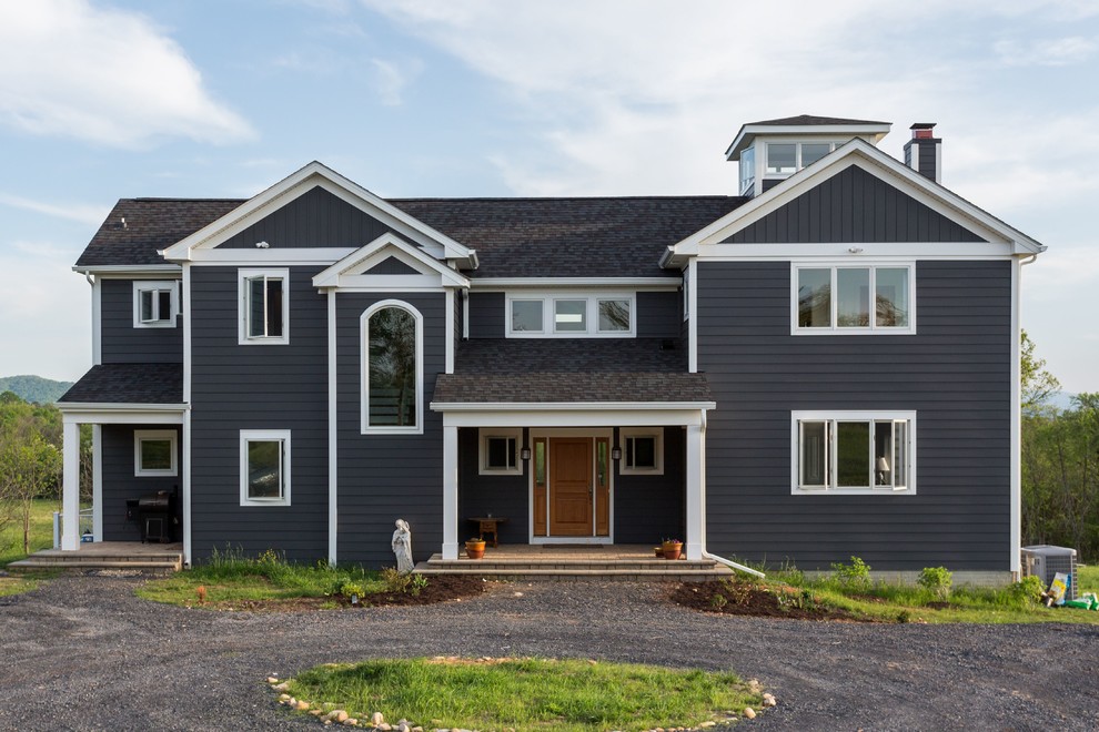 This is an example of a large transitional two-storey grey house exterior in DC Metro with wood siding, a gable roof and a shingle roof.