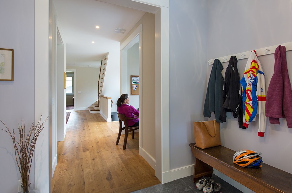 Inspiration for a mid-sized country medium tone wood floor hallway remodel in Boston with gray walls