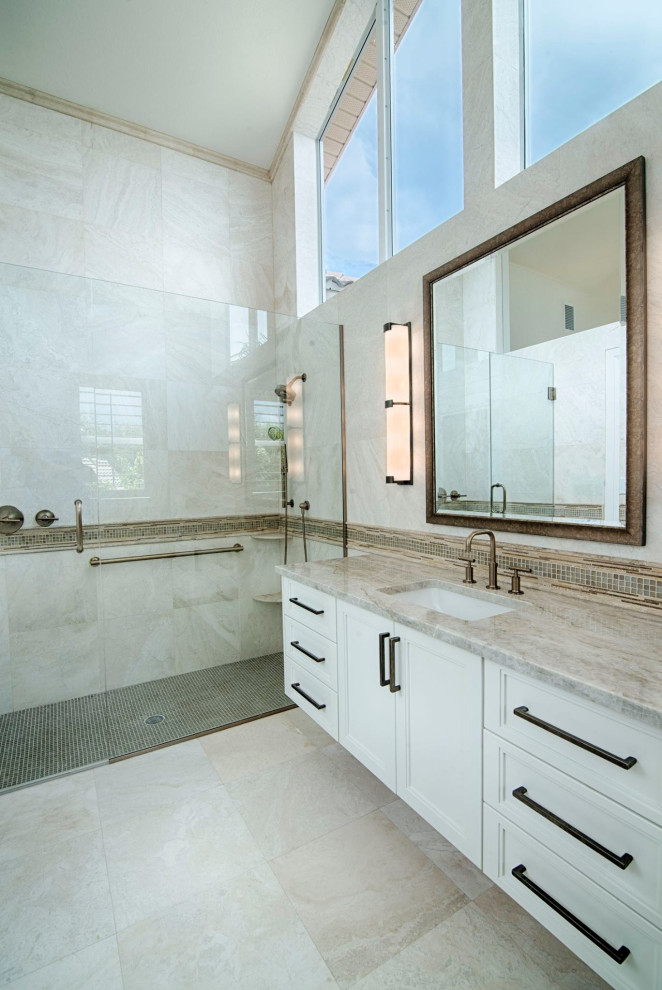 Inspiration for a mid-sized transitional master bathroom with shaker cabinets, white cabinets, a curbless shower, a one-piece toilet, marble, marble floors, an undermount sink, marble benchtops, a hinged shower door, a double vanity, a floating vanity and vaulted.