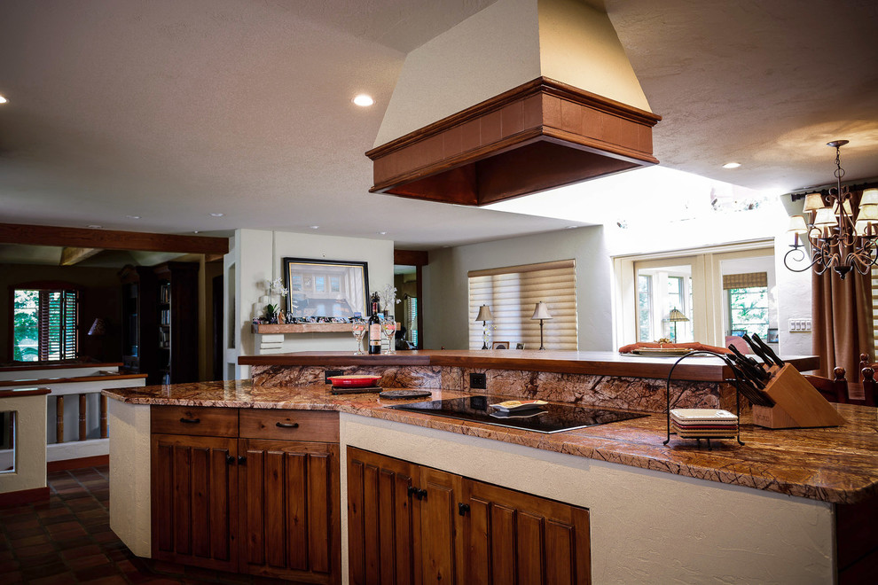 Mid-sized mountain style u-shaped terra-cotta tile open concept kitchen photo in Boston with an undermount sink, dark wood cabinets, granite countertops and an island