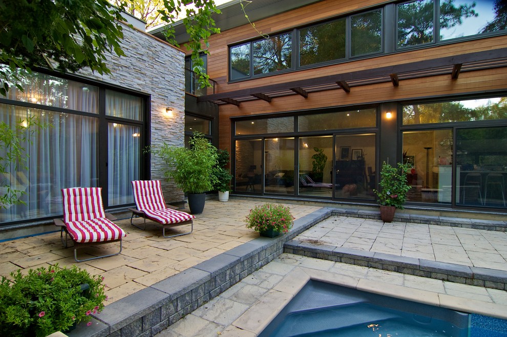 This is an example of a contemporary patio in Toronto with a pergola.