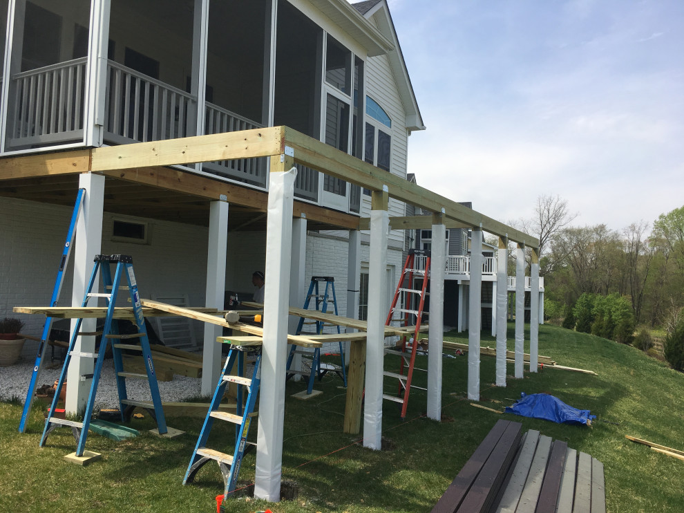 Example of a large backyard second story cable railing deck design in Baltimore