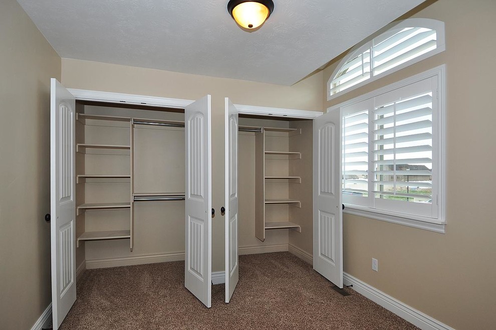 Large arts and crafts women's built-in wardrobe in Salt Lake City with carpet.
