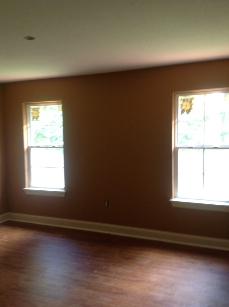 Mid-sized mountain style master dark wood floor bedroom photo with beige walls