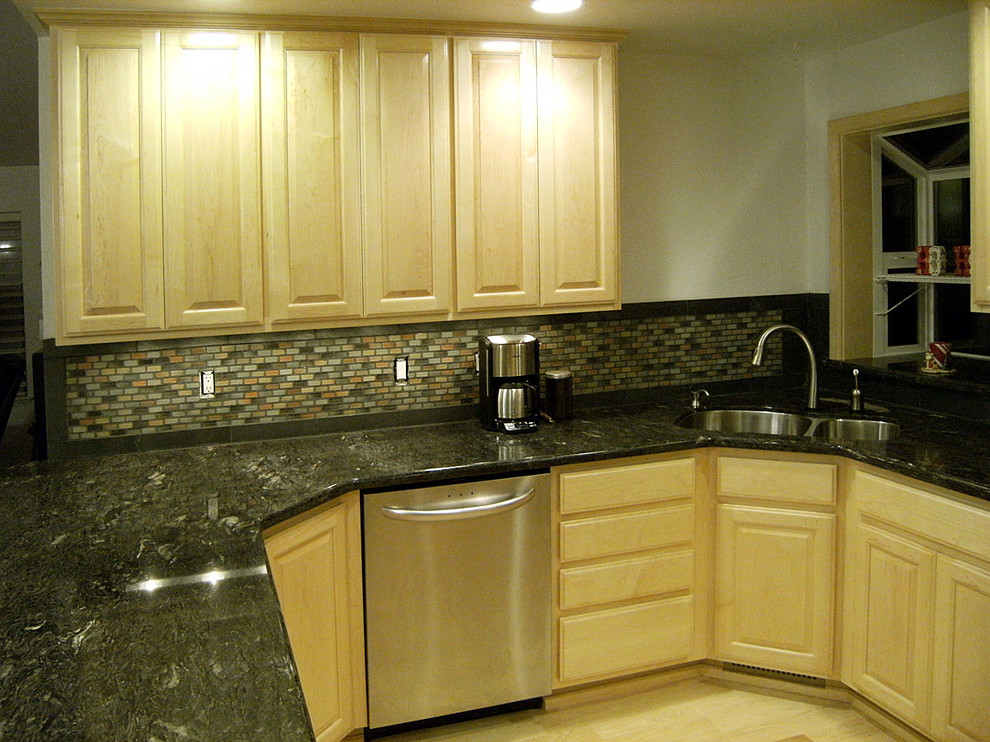 Inspiration for a brown floor kitchen remodel with raised-panel cabinets and stainless steel appliances