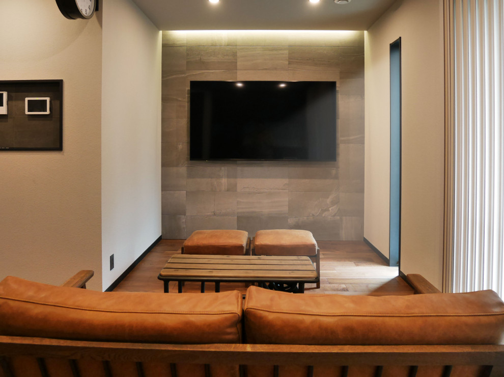 Пример оригинального дизайна: открытая гостиная комната в стиле модернизм с с книжными шкафами и полками, белыми стенами, паркетным полом среднего тона, телевизором на стене, белым полом, потолком с обоями, обоями на стенах и коричневым диваном без камина