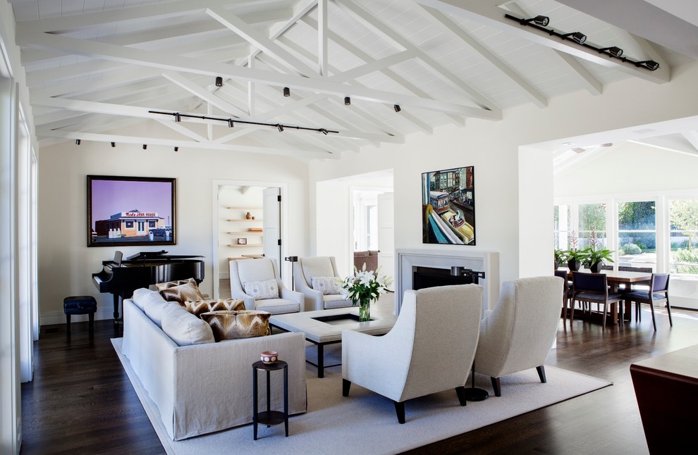Inspiration for a large transitional open concept living room in San Francisco with a music area, white walls, dark hardwood floors, a standard fireplace, a plaster fireplace surround, no tv and brown floor.