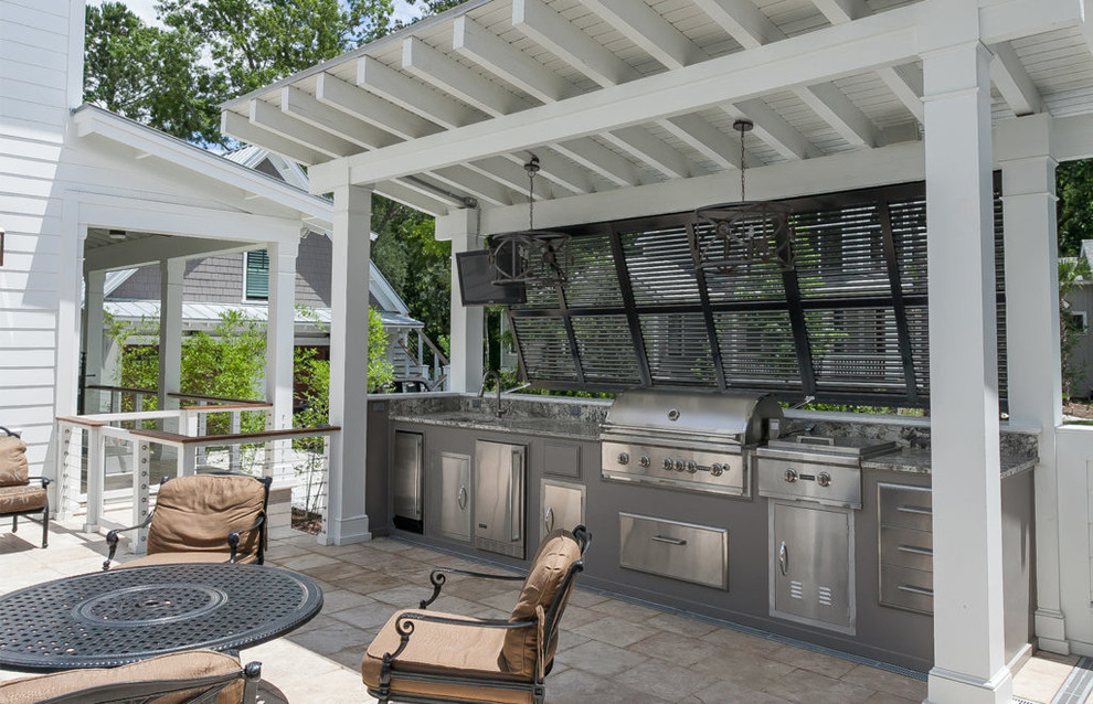 Inspiration for a mid-sized contemporary side yard patio in Charleston with an outdoor kitchen, natural stone pavers and a pergola.