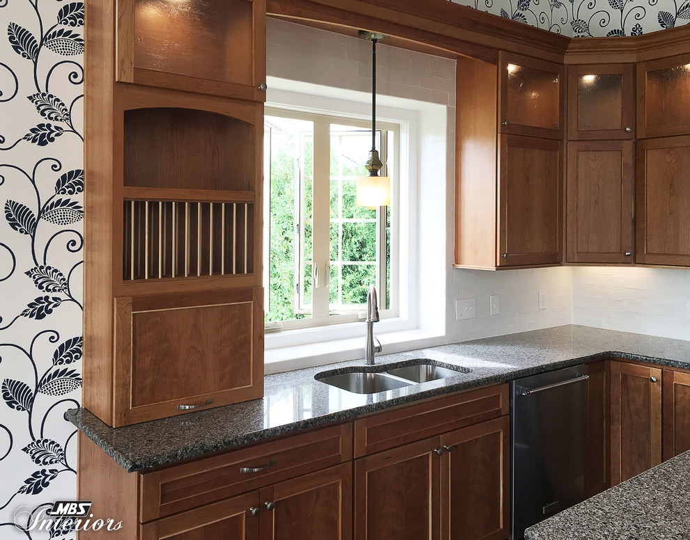 Eat-in kitchen - mid-sized transitional l-shaped dark wood floor and brown floor eat-in kitchen idea with an undermount sink, recessed-panel cabinets, medium tone wood cabinets, granite countertops, white backsplash, ceramic backsplash, stainless steel appliances and an island