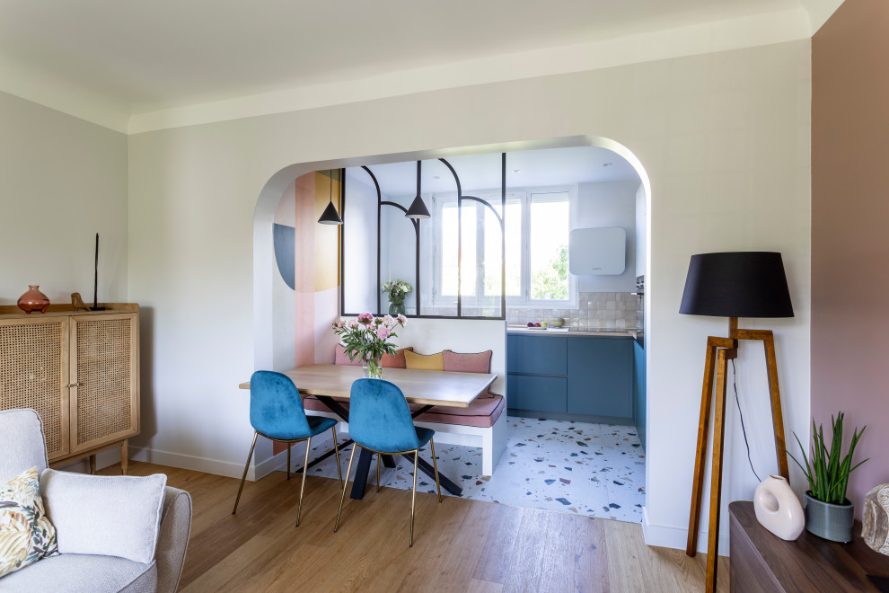 Идея дизайна: угловая кухня среднего размера в современном стиле с обеденным столом, монолитной мойкой, плоскими фасадами, зелеными фасадами, столешницей из ламината, фартуком из плитки мозаики, полом из терраццо и мойкой у окна