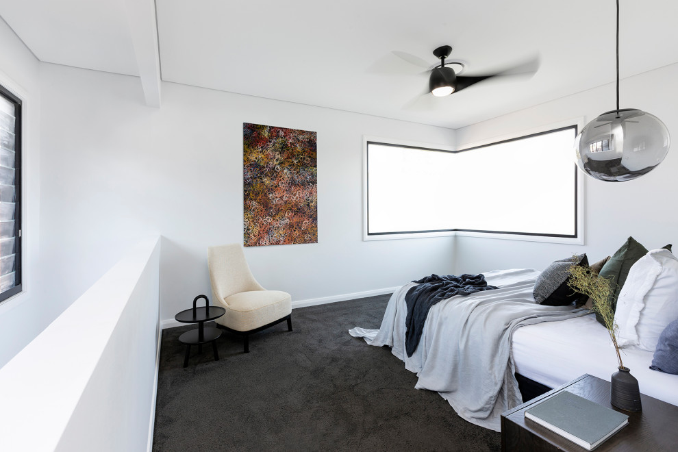 This is an example of a large contemporary master bedroom in Sydney with white walls, carpet and black floor.