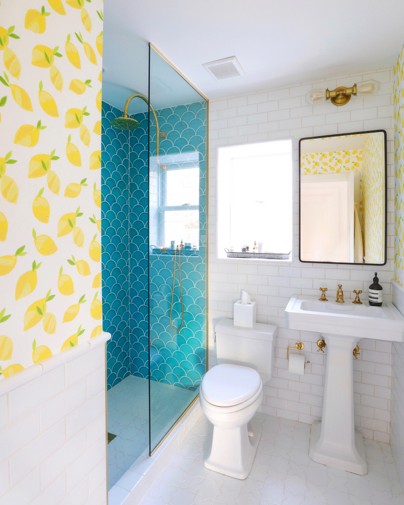 Inspiration for a mid-sized beach style 3/4 bathroom in New York with white cabinets, an alcove shower, blue tile, ceramic tile, multi-coloured walls, ceramic floors, a pedestal sink, white floor, an open shower, a single vanity and wallpaper.