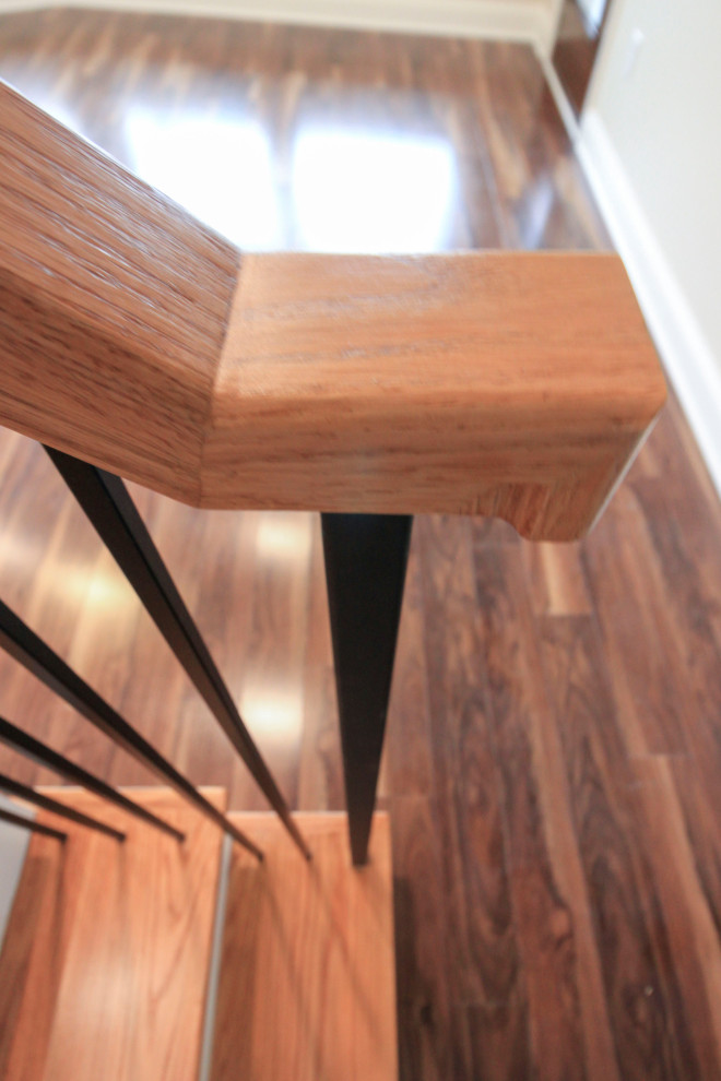 Inspiration for a large transitional wood floating staircase in DC Metro with wood risers, mixed railing and planked wall panelling.