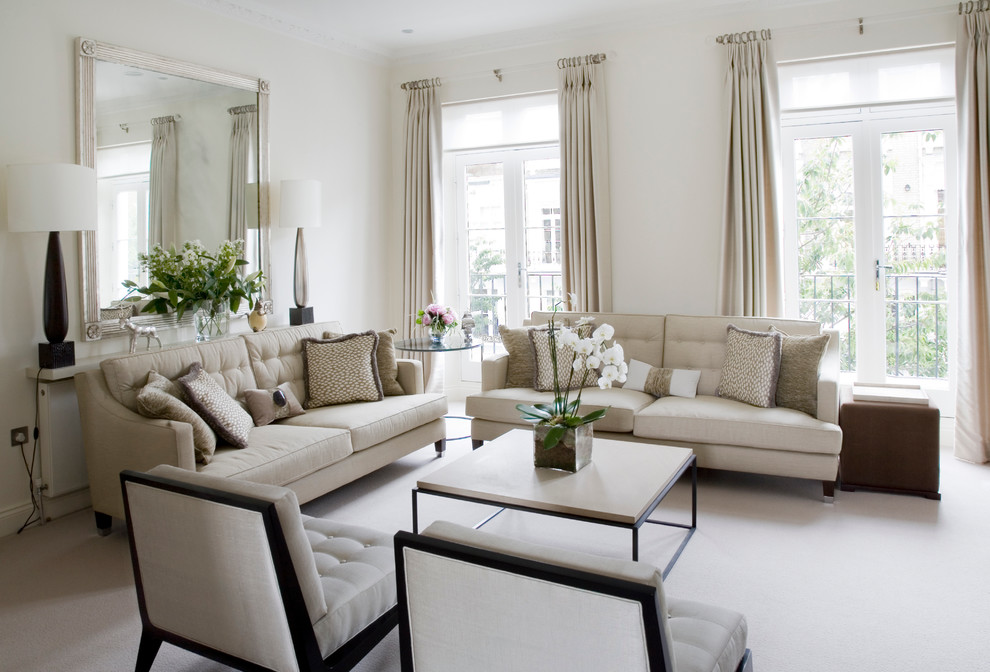 Inspiration for a transitional formal living room in London with white walls and carpet.