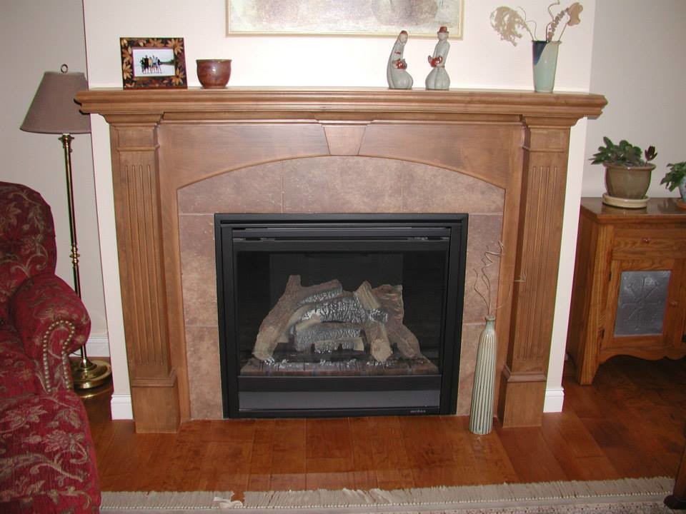 Living room - medium tone wood floor living room idea with beige walls, a standard fireplace and a wood fireplace surround