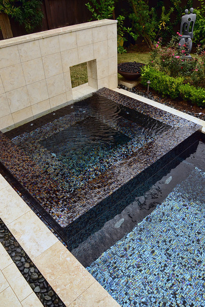 Design ideas for a large midcentury backyard custom-shaped pool in Houston with a hot tub and tile.