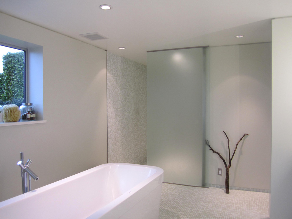 This is an example of a modern bathroom in Seattle with a freestanding tub and mosaic tile.