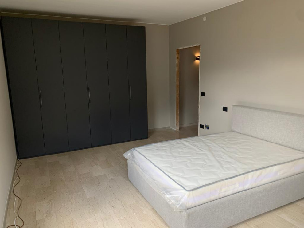 This is an example of a large modern bedroom in Other with ceramic flooring and white floors.