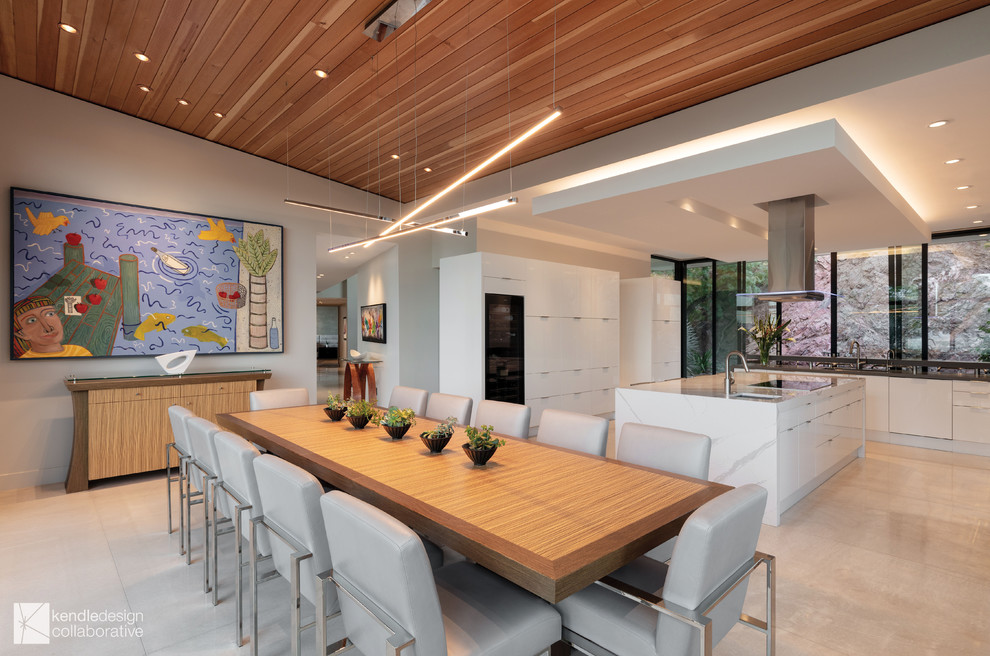 Design ideas for a large contemporary u-shaped eat-in kitchen in Phoenix with an undermount sink, flat-panel cabinets, white cabinets, quartz benchtops, stainless steel appliances, concrete floors, with island, white floor and white benchtop.