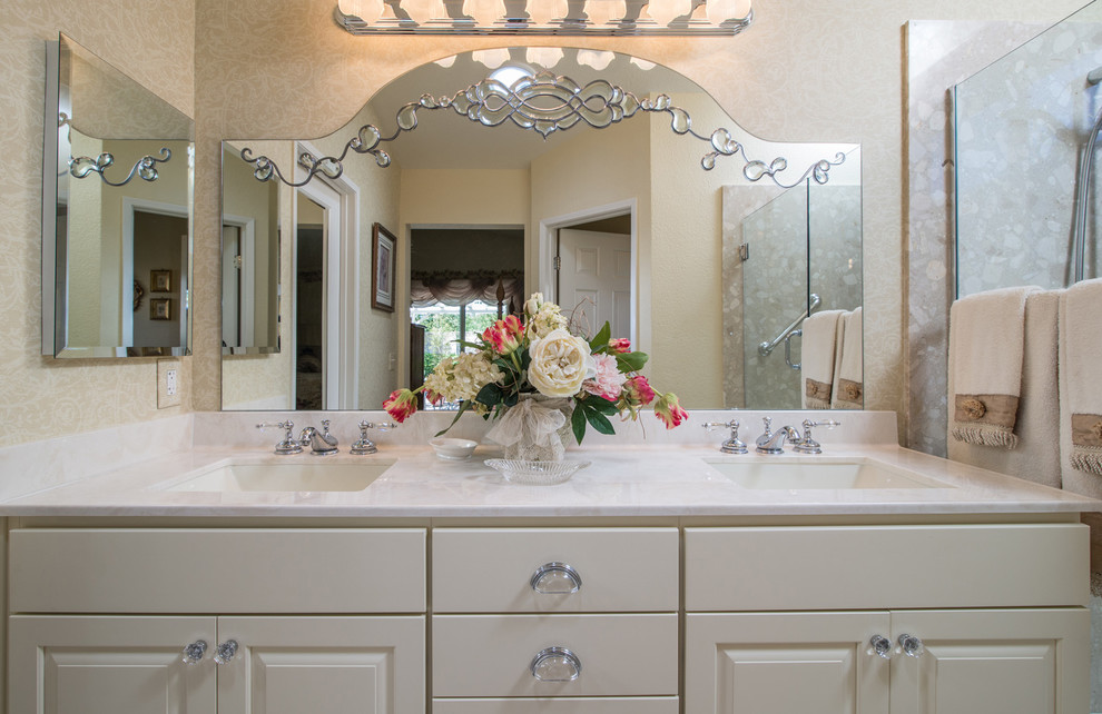 Inspiration for a mid-sized traditional 3/4 bathroom in San Diego with an undermount sink, raised-panel cabinets, white cabinets, marble benchtops, an alcove shower, a one-piece toilet and beige walls.
