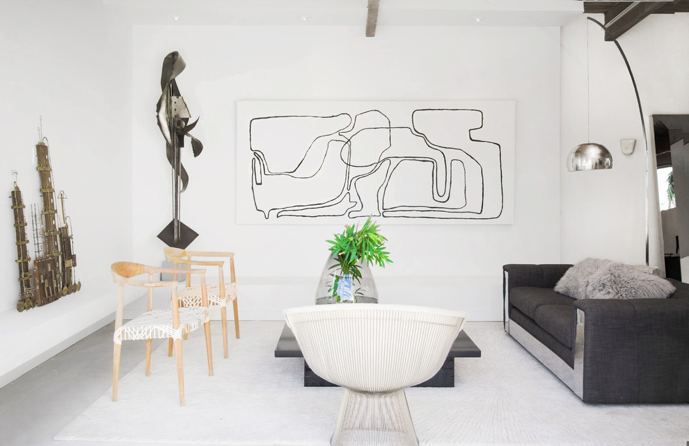 This is an example of a beach style formal living room in Los Angeles with white walls.