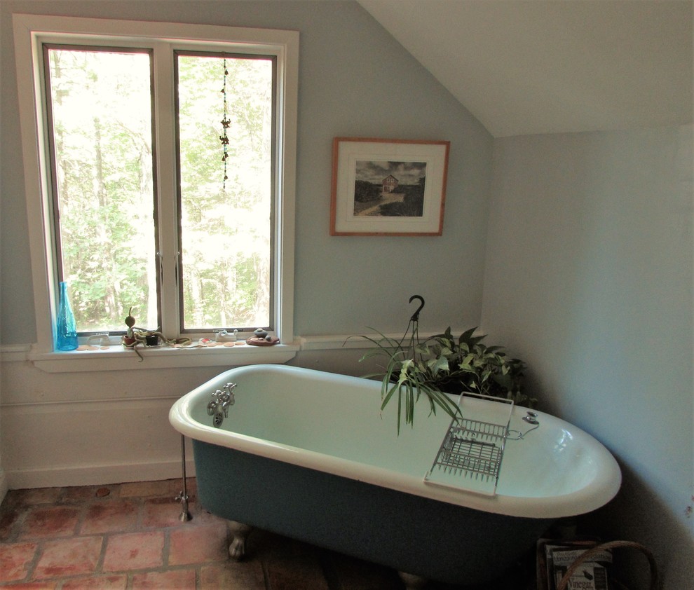 This is an example of a mid-sized country master bathroom in Boston with flat-panel cabinets, white cabinets, a claw-foot tub, an open shower, a two-piece toilet, white tile, subway tile, blue walls, terra-cotta floors, soapstone benchtops and a shower curtain.