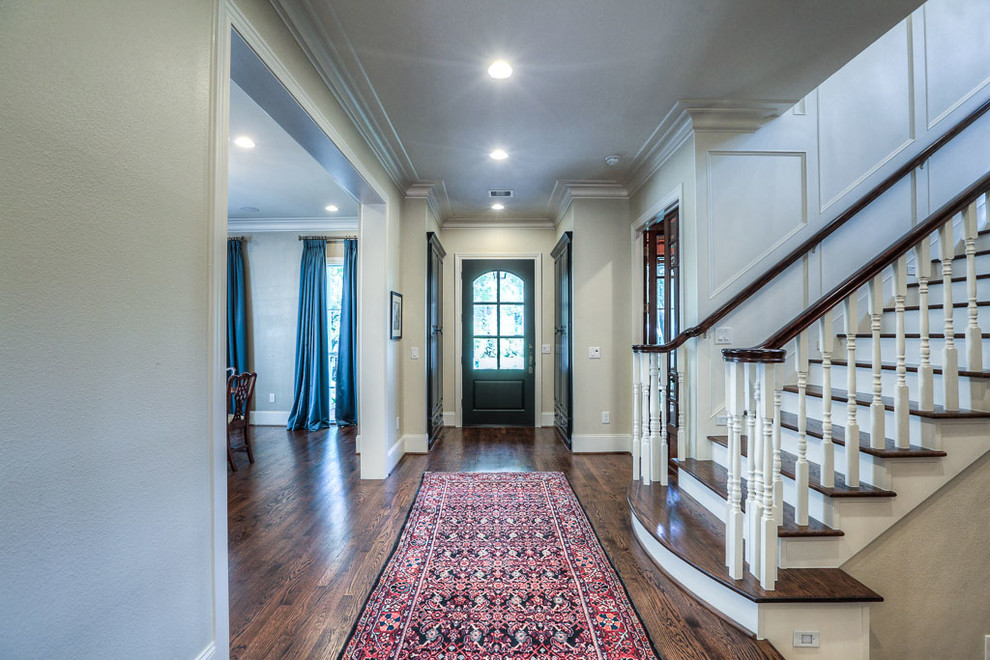 Design ideas for a mid-sized traditional foyer in Houston with beige walls, dark hardwood floors, a single front door and a black front door.