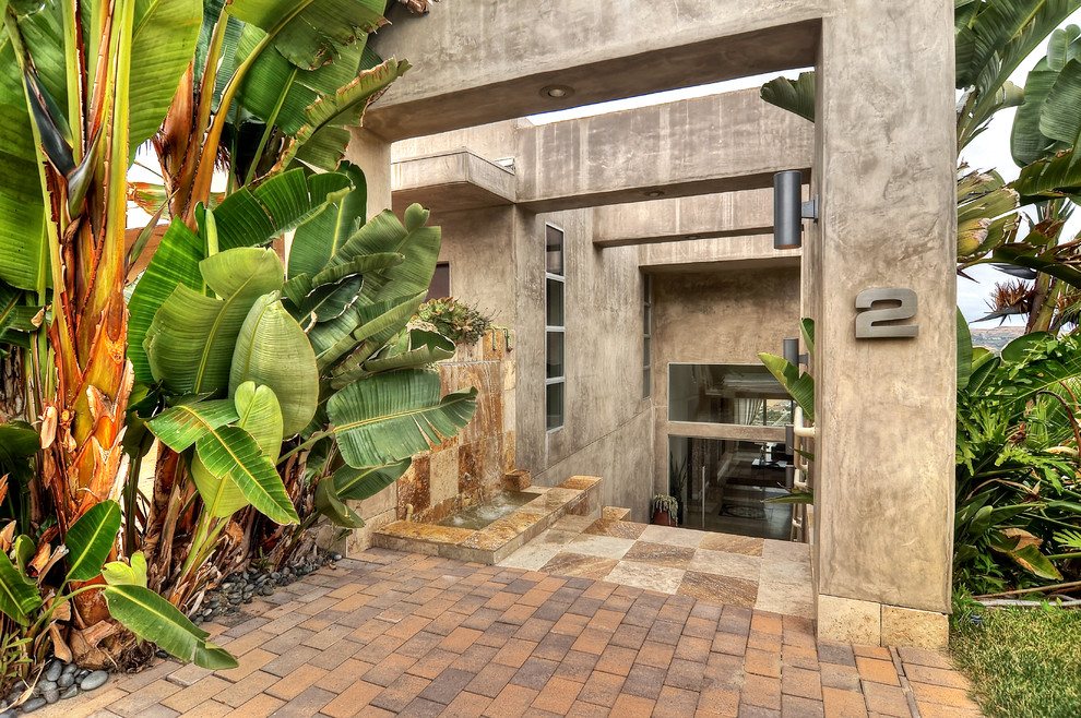 This is an example of a mid-sized industrial courtyard partial sun garden in Orange County with concrete pavers.