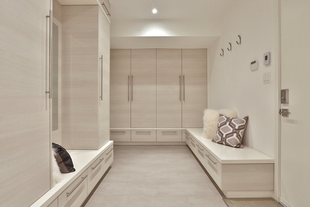 Design ideas for a mid-sized contemporary mudroom in Toronto with white walls, a single front door and a white front door.