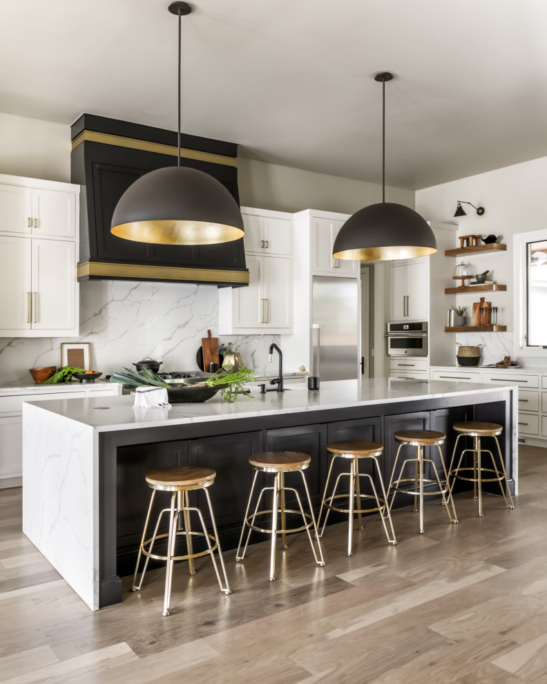 Design ideas for a transitional kitchen in Oklahoma City with quartz benchtops and light hardwood floors.