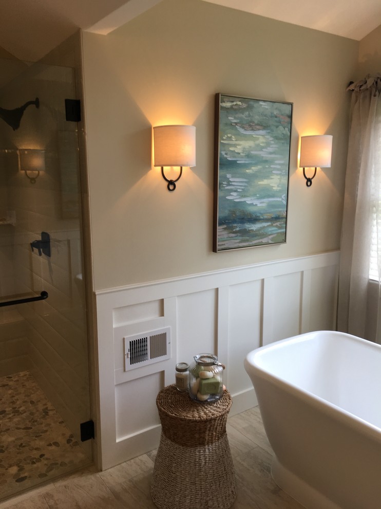 Design ideas for a mid-sized transitional master bathroom in DC Metro with raised-panel cabinets, beige cabinets, a freestanding tub, an alcove shower, white tile, beige walls, ceramic floors, an undermount sink, granite benchtops, beige floor and a hinged shower door.