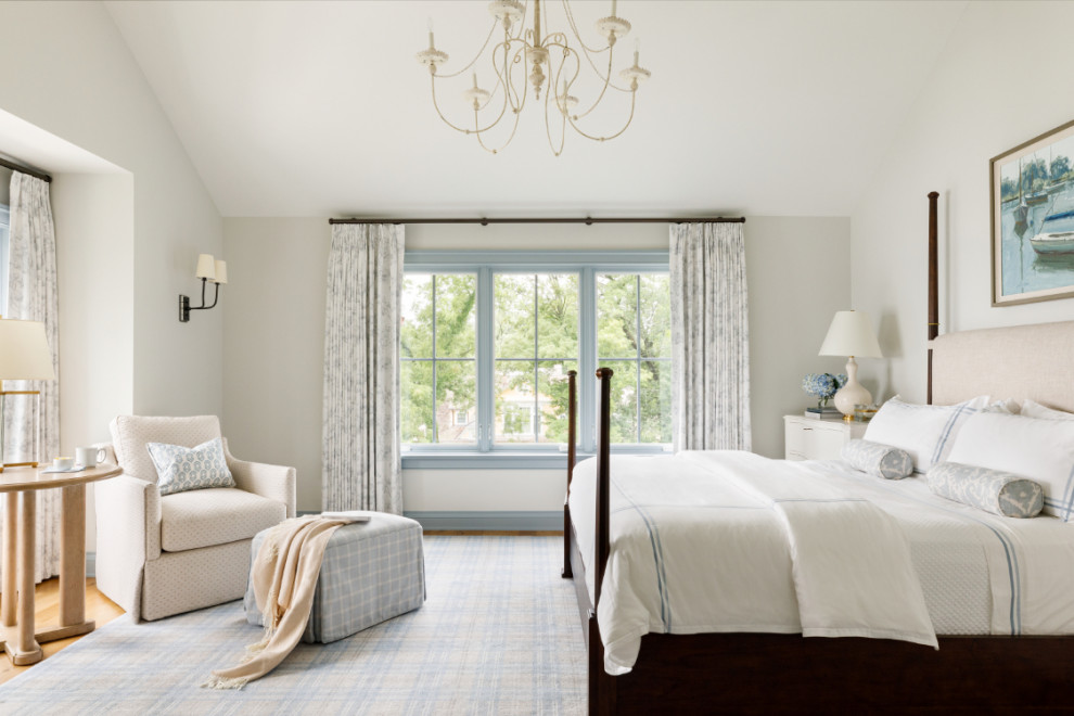 Design ideas for a large beach style master bedroom in Milwaukee with white walls, medium hardwood floors and vaulted.