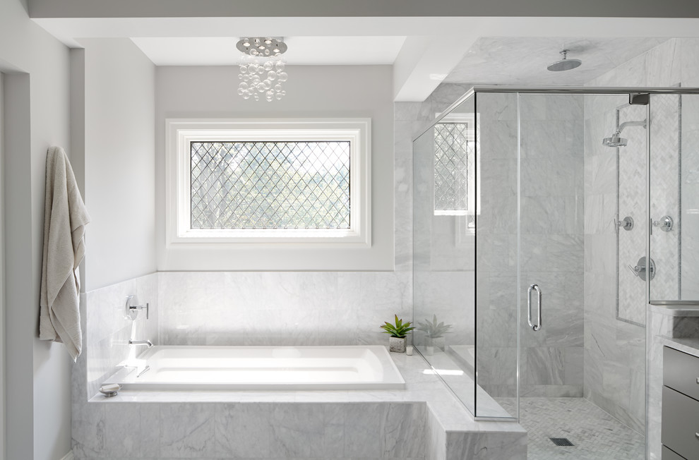 Design ideas for a mid-sized transitional master bathroom in Chicago with a drop-in tub, white tile and grey walls.