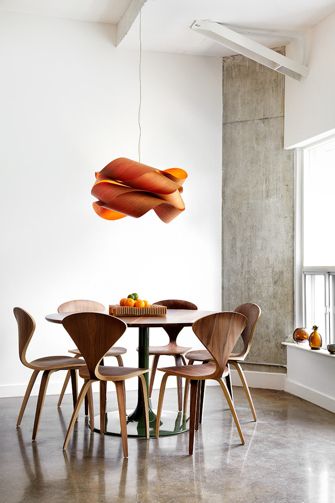 Design ideas for a contemporary dining room in Toronto with white walls and concrete floors.