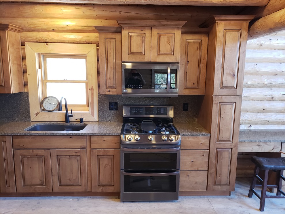 Example of a mountain style kitchen design in Phoenix with medium tone wood cabinets